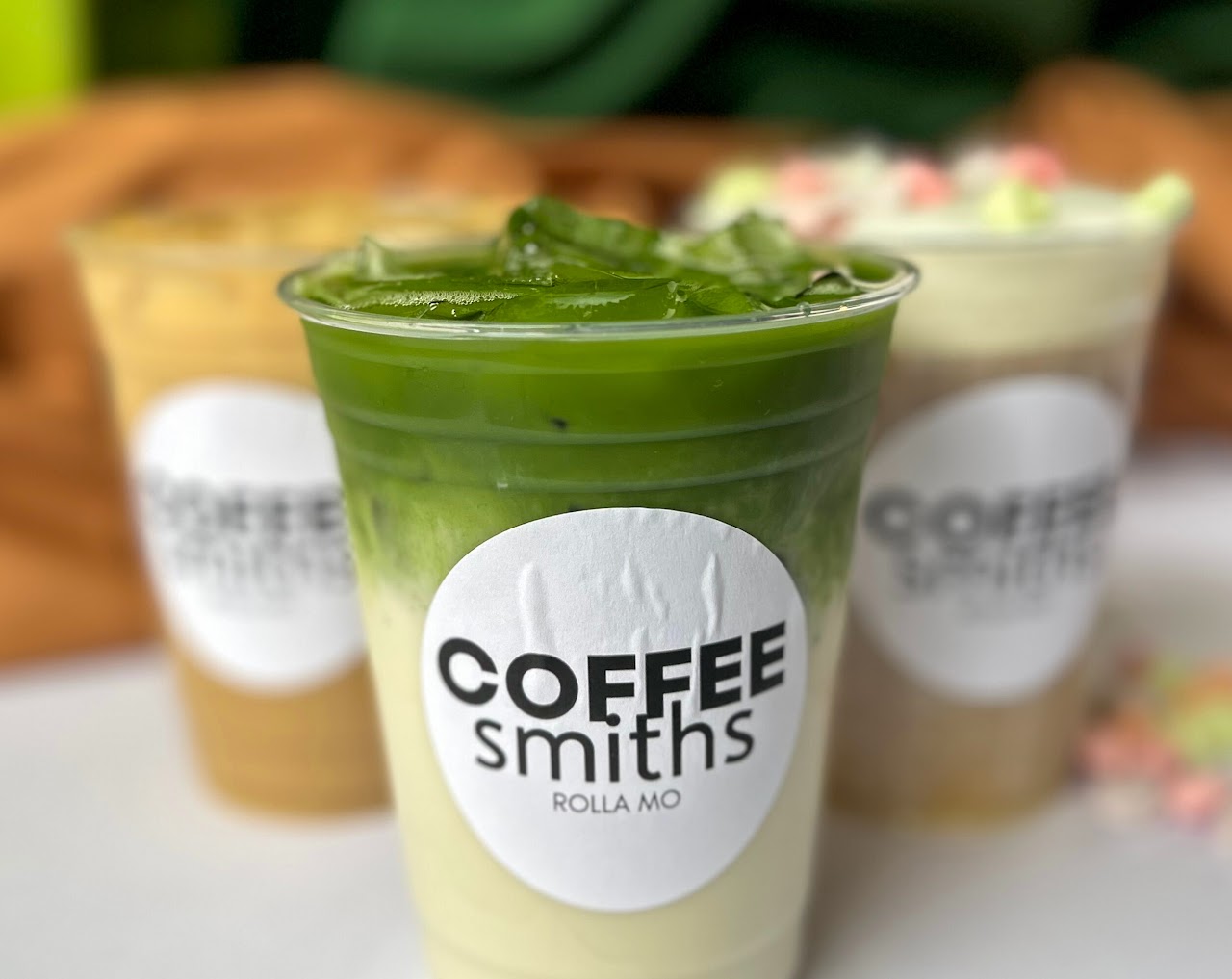 A trio of iced Coffeesmiths drinks in branded cups