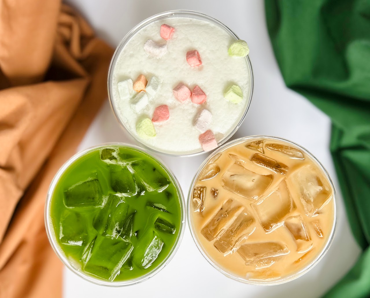 Three handcrafted drinks lined up on the counter